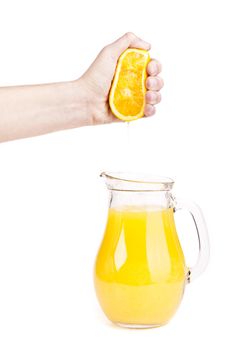 hand pour orange juice from orange