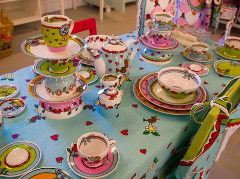 Country style dining room table arranged with traditional hand painted dishes
