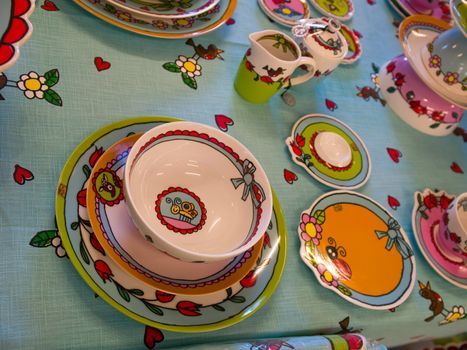 Country style dining room table arranged with traditional hand painted dishes