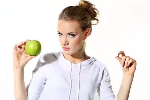 Girl with a green apple on a white background