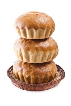 fresh baked rolls with grain in a basket on white