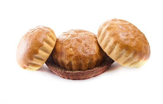 three fresh baked rolls in a basket on white