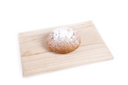 The fresh bun isolated on wooden plate