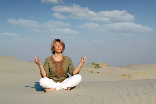 beautiful woman meditating in desert healthy lifestyle