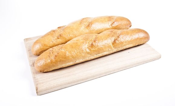 fresh baguette on wooden plate