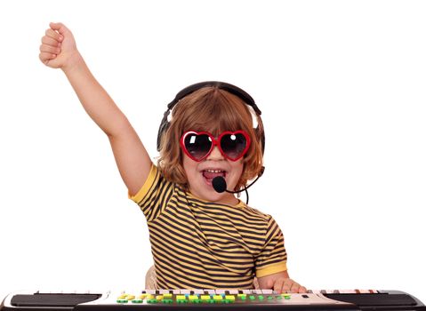 happy little girl play keyboard and sing