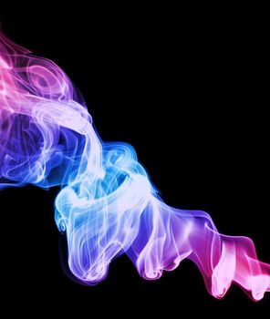 A swirled spiral of colored smoke on a black background