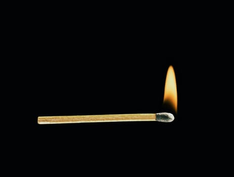 Burning match on a black background