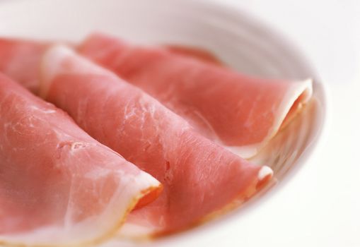 smoked meat slices on a white plate