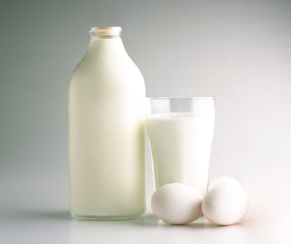 milk bottle and eggs isolated on white background