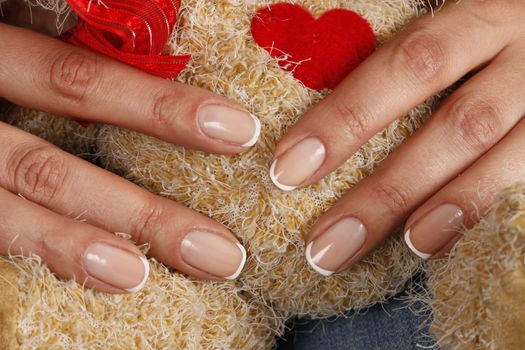 Toy with heart in female hands