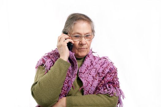 old woman talking on the phone on white background