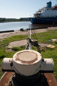 Bollard Tied with rope at a pier