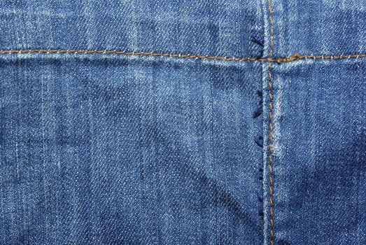 Blue jeans with yellow thread. Use as backdrop, background.