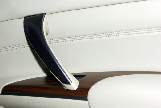 Interior of modern car as background. High quality leather Leather, wood and aluminium.