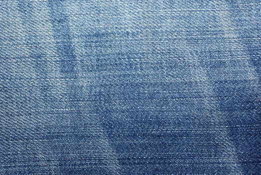 Blue worn jeans cloth textured abstract background.