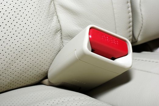 Close up photo of seat belt press button. Interior of modern japanese car.