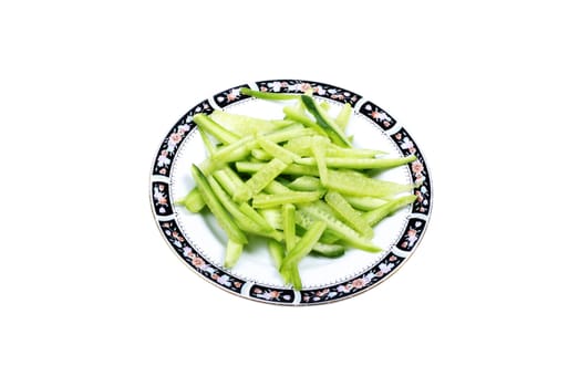  Cutted cucumber laying on plate isolated on white background.