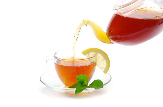 tea being poured into glass tea cup