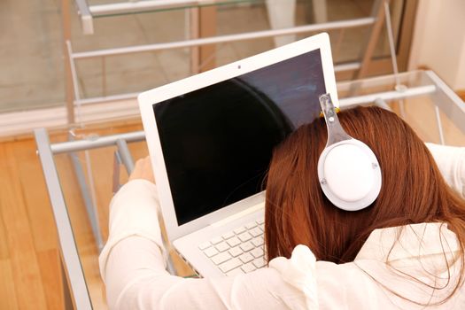 A woman sleeping on the Laptop.