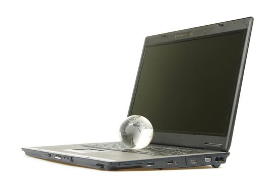 glass globe placed on a laptop isolated on white