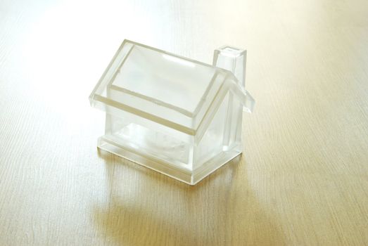 Crystal house isolated on wood background