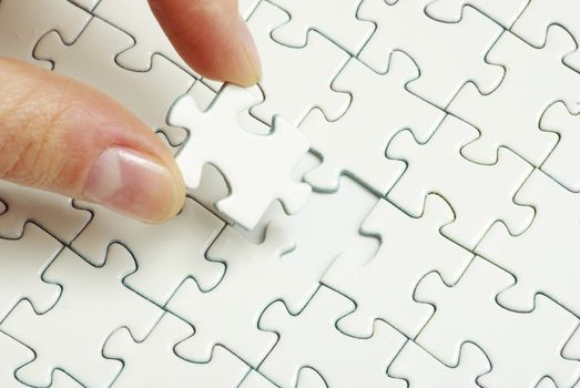 hands holding a puzzle piece . business concepts