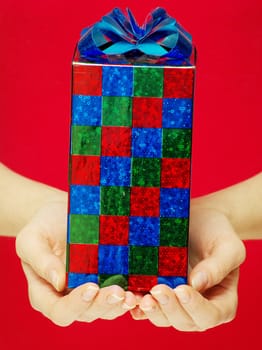 christmas gift in hands isolated on red 