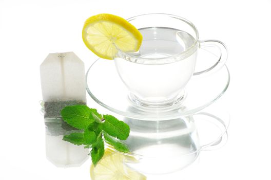 tea in cup with leaf mint and lemon