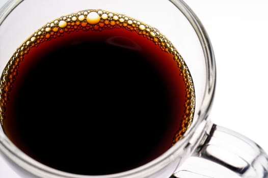 Coffee in glass  cup on white background (seen from above) closeup