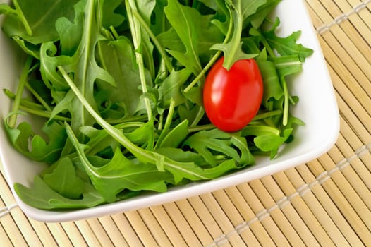 Salad with arugula and cherry tomato (closeup)