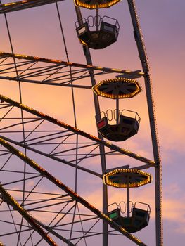 a ferris wheels gondolas at dusk