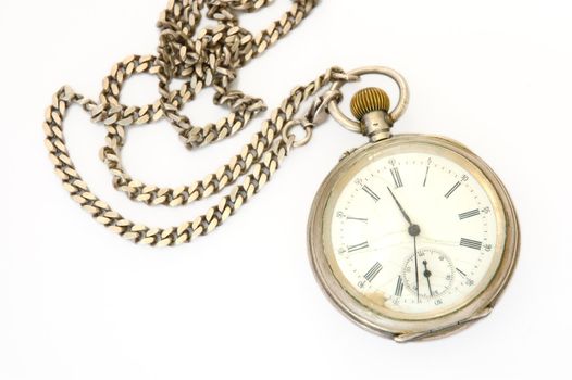 Old silver pocket watch with fob on overwhite background.