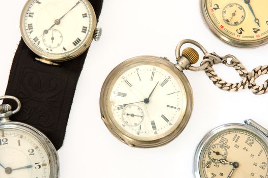 Many different old watches on overwhite background.