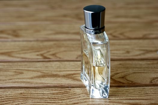 Mens Perfume and Fragrance in a wooden tile background