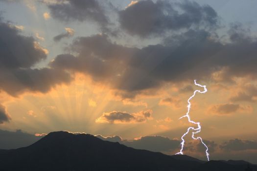 Dramatic Sunset in a beautiful landscape-mountain and Lightning