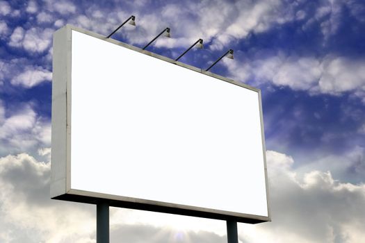 Blank Billboard  with lamps and blank screen for commercial use, in a beautiful blue sky background