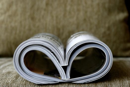 Magazine rolled shaped into hearth in a cosy sofa