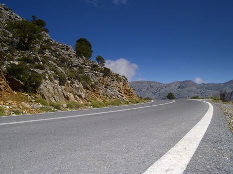 road in cretan mountains on a bright sunny day