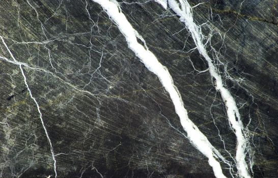 Black marble with white veins and a smattering of grey color