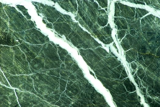 Green marble with white veins and a smattering of grey color