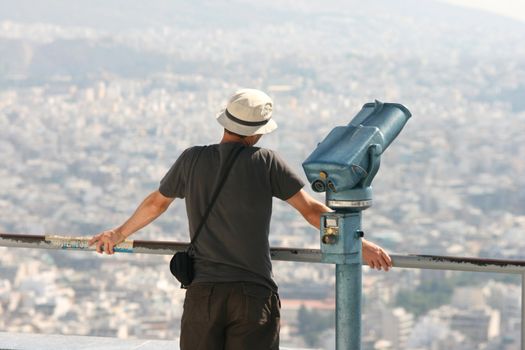 man tourist watching the view of athens from the top of lycabetus