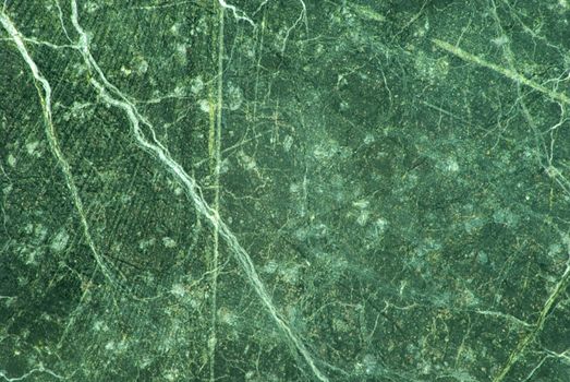 Green marble with white veins and a smattering of grey color