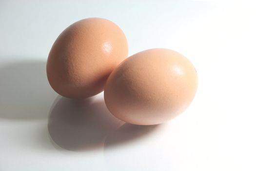 two eggs with hard shadow and reflection