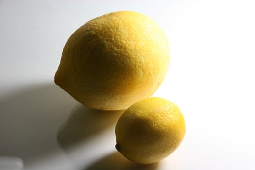 two lemons horizontal with dramatic shadows