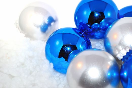 Blue and silver ornaments with artifition snow isolated on the white. 