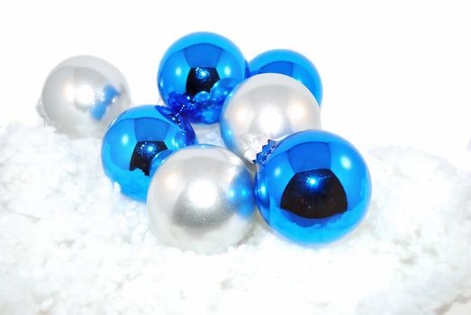 Blue and silver ornaments with artifition snow isolated on the white.