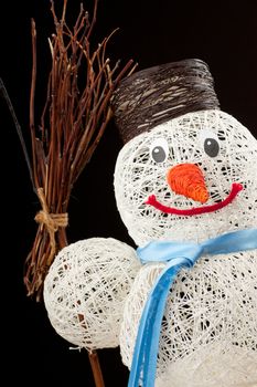 A snowman made of thread over black background