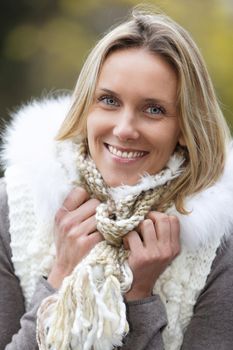 beautiful blond woman smiling outdoor in autumn