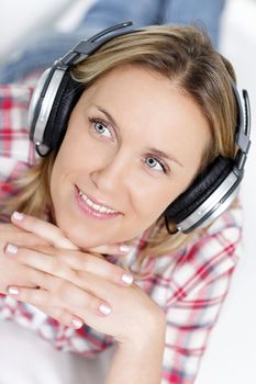 beautiful blond woman listening music with headphone